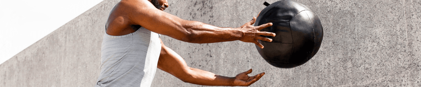 Man throwing medicine ball